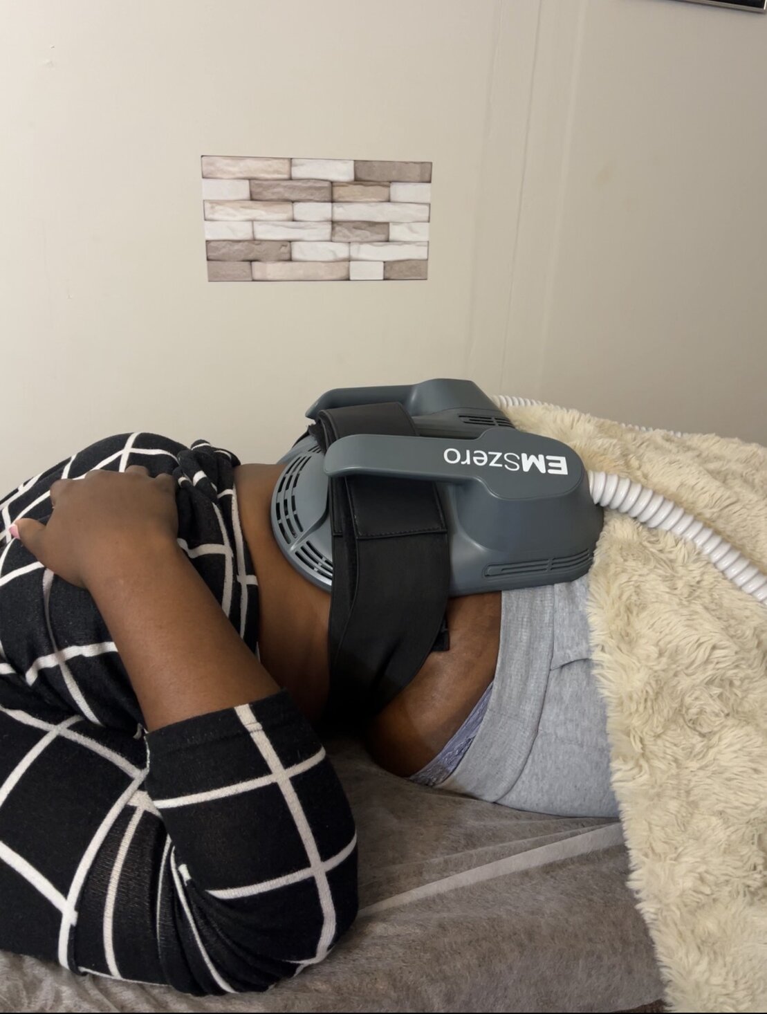 EMS body contouring machine treating abdominal muscles