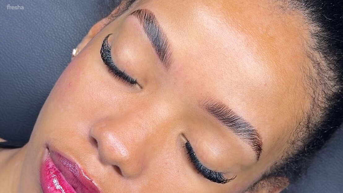Close-up of full lashes and defined eyebrows