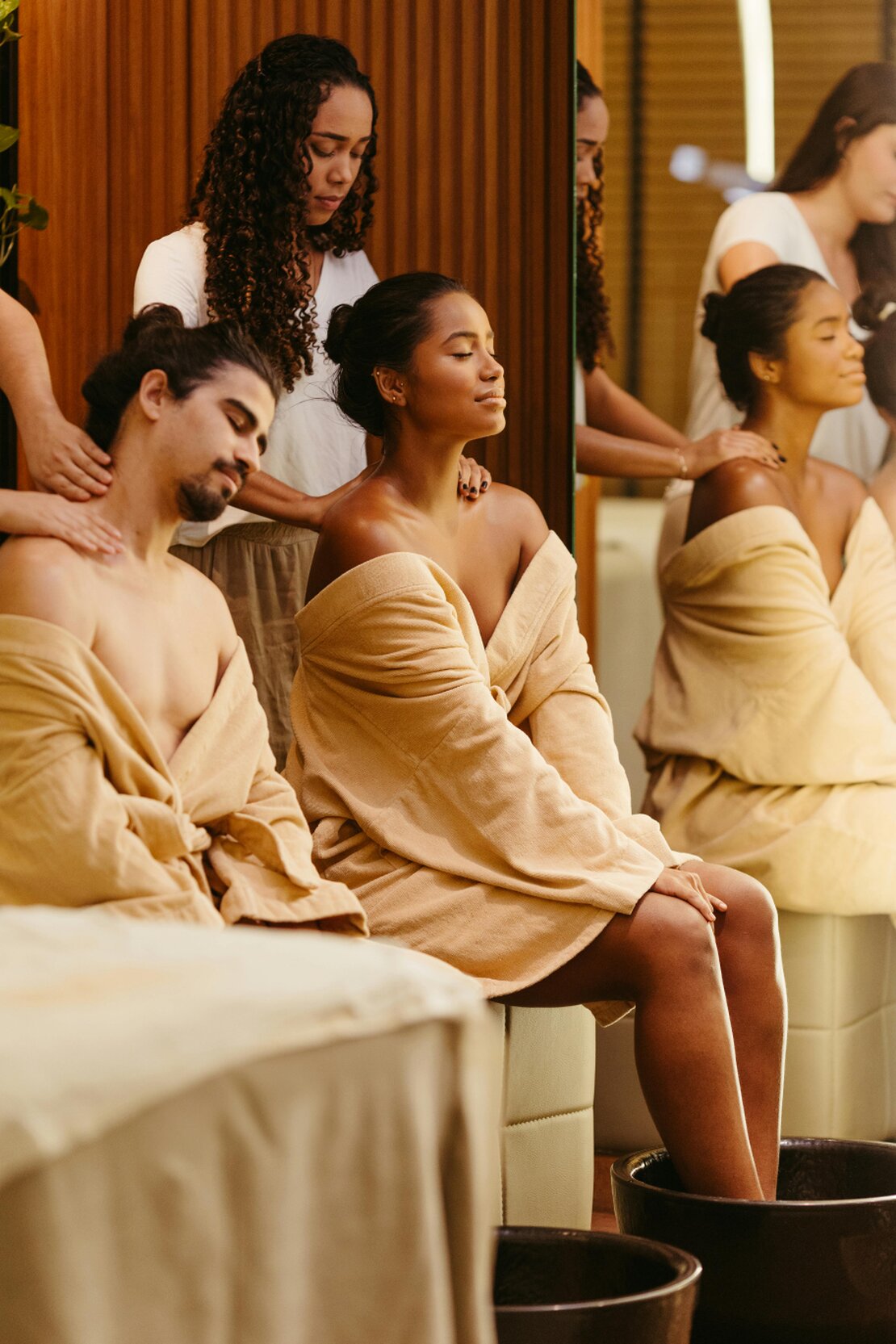 Diverse group of clients smiling in a beauty clinic lounge