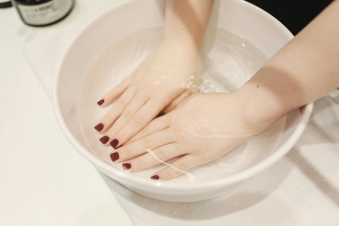 Client receiving a relaxing hand and foot rejuvenation treatment