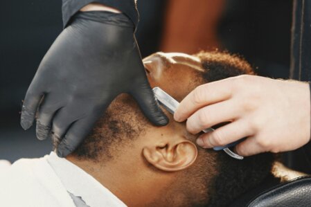 Male client receiving a beard and head care facial treatment
